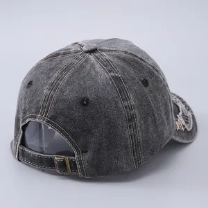 Detail of vintage washed grey cotton baseball cap with adjustable metal back strap buckle