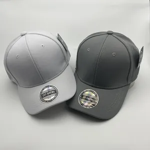 Close-up of breathable honeycomb fabric on gray baseball caps with size stickers