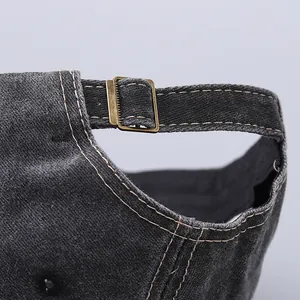 Close-up of adjustable bronze metal buckle on vintage washed cotton baseball cap
