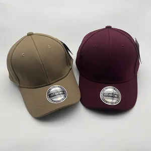Close-up of khaki and wine red baseball caps with 57-58cm size stickers and fine texture