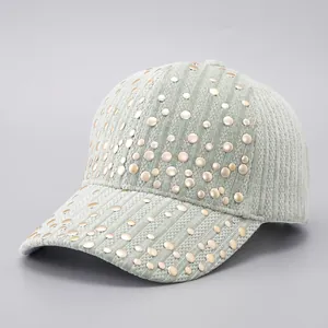Sage green corduroy baseball cap with stylish gold rivet studs and textured fabric