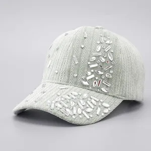 Detail of light green corduroy baseball cap with sparkling rhinestone embellishments