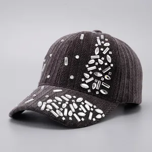 Detail of dark grey ribbed baseball cap featuring sparkling mixed-cut crystal rhinestones