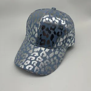 Detailed view of blue denim baseball cap with metallic silver leopard print texture