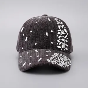Detail of dark grey knit baseball cap featuring luxury rhinestone crystal embellishments