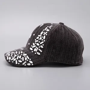 Detailed view of the sparkling rhinestones on grey corduroy baseball cap surface
