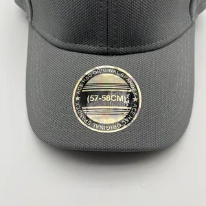 Detailed macro view of dark grey baseball cap breathable fabric and round silver sticker