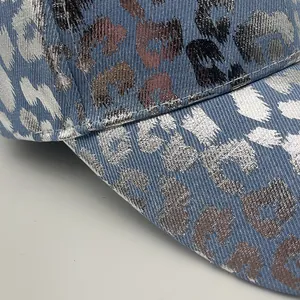 Blue baseball cap with metallic silver and bronze leopard print pattern details