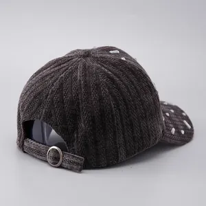 Detail of dark grey corduroy baseball cap with rhinestone accents and metal buckle