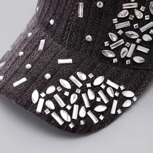 Macro view of grey corduroy baseball cap featuring sparkling rhinestone embellishments