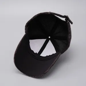 Detail view of winter suede baseball cap with six-panel structure and adjustable metal buckle