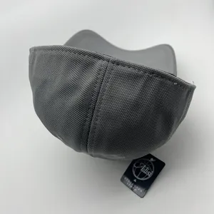 Detail shot of the gray baseball cap back panel and brand tag on white background