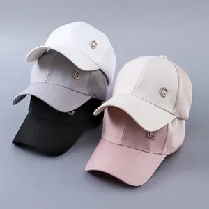 Detail of five multi-color baseball caps featuring mesh back and crystal G logo