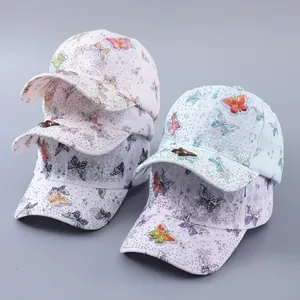 Detail of lace baseball caps with 3D butterfly embroidery and shiny rhinestones