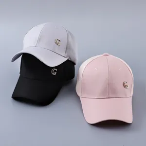 Detailed view of breathable mesh baseball caps in grey, black, and pink with G-logo