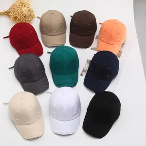 Detailed overhead view of distressed vintage baseball caps in ten assorted colors