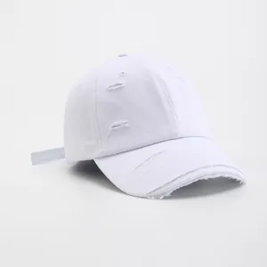 Vintage distressed white cotton baseball cap with ripped details and six-panel structure
