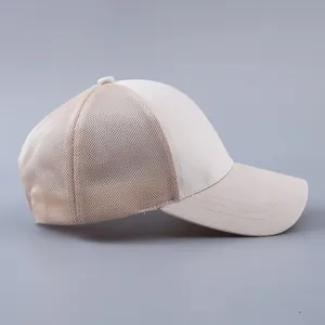 Detailed side view of beige mesh baseball cap with breathable polyester panels and curved brim
