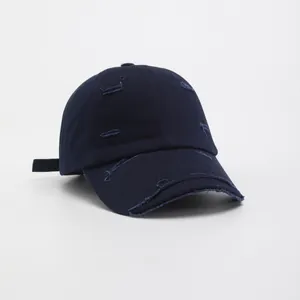 Close-up of distressed vintage navy blue cotton baseball cap with ripped details