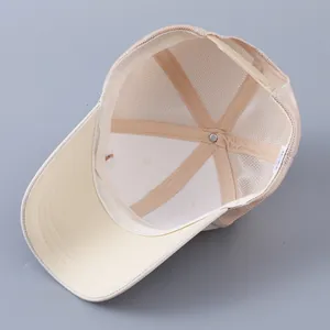 Internal view of beige mesh baseball cap showing breathable stitching and adjustable strap