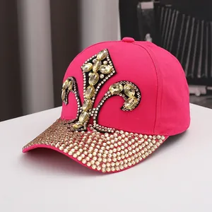 Detailed macro view of rhinestone fleur-de-lis pattern on a hot pink cotton baseball cap