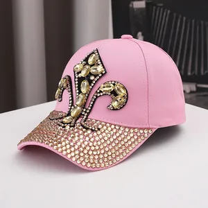 Detail of pink cotton baseball cap with gold fleur-de-lis rhinestones and crystal brim