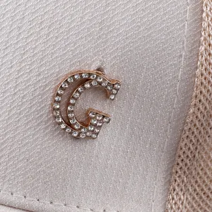 Macro detail of breathable mesh baseball cap with sparkling rhinestone metal G-logo