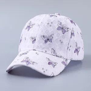 Detailed view of white lace baseball cap featuring elegant purple butterfly prints