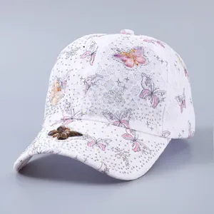 Close-up of white lace baseball cap featuring 3D butterfly decor and sparkling rhinestones