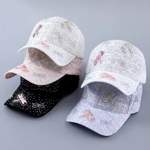 Detailed stack of lace baseball caps with rhinestone dragonflies in multiple colors