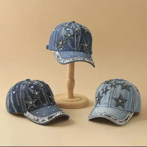 Detail showing various denim wash shades of baseball caps with rhinestones and star patterns