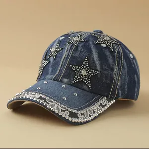 Detailed macro view of denim baseball cap with silver rhinestones and star patch accents