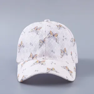 Detailed view of pink lace baseball cap featuring butterfly prints and star patterns