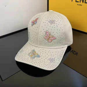 Detail of baseball cap featuring rhinestones and three 3D embroidered colorful butterflies