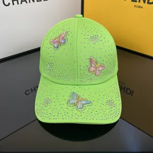 Detailed shot of vibrant neon green baseball cap featuring crystal butterfly embellishments