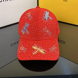 Macro detail of red baseball cap with sparkling rhinestones and colorful dragonflies