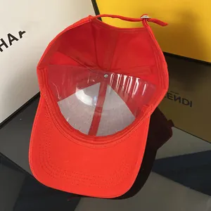 Detailed interior of red cotton baseball cap showing metal buckle and inner structure