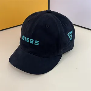 Close-up of black baseball cap with blue BIEBS embroidery and side triangle tag detail
