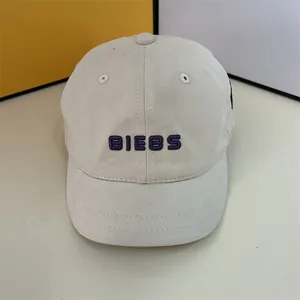 Close-up of beige twill cotton baseball cap with purple BIEBS 3D embroidery detail