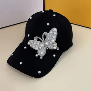 Elegant black baseball cap featuring a large butterfly patch with pearls and rhinestones