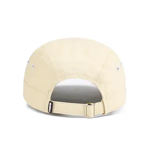Detail of adjustable metal buckle and strap on back of cream 5-panel camper hat