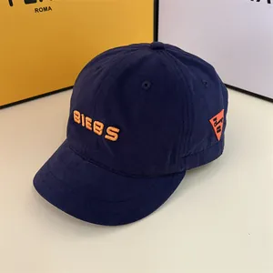 Detailed embroidery of orange BIEBS letters on high-quality navy blue twill baseball cap