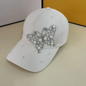 Elegant cream baseball cap with pearl butterfly and rhinestones decoration