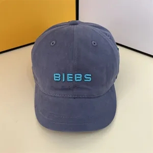 Close-up of BIEBS embroidery on a gray-blue cotton baseball cap with a curved brim