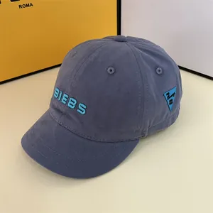 Detailed close-up of blue short brim baseball cap with 3D BIEBS embroidery and soft fabric