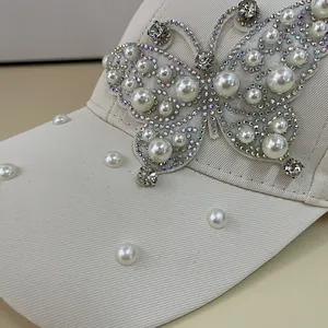 Beige baseball cap with elegant rhinestone butterfly and pearl embellishments