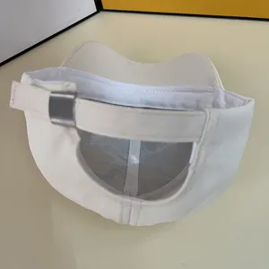Detail of white baseball cap showing adjustable silver metal buckle and inner mesh lining