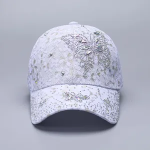 Detailed close-up of light purple lace baseball cap with sparkling rhinestone butterfly