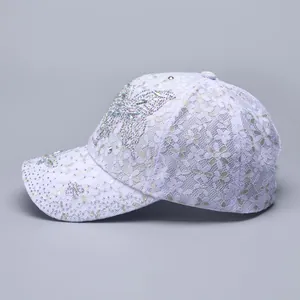 Close-up of lavender lace baseball cap with sparkling rhinestone butterfly and floral details