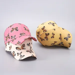 Detailed display of colorful baseball caps featuring glitter butterfly prints in three shades